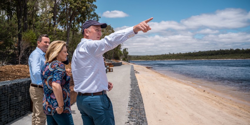 Minister Stephen Dawson points to the water of Lake Kepwari as he stands at the water's edge alongside Premier Mark McGowan