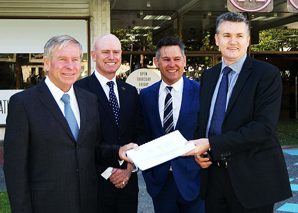 Colin Barnett and three men holding a document.