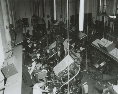 Photograph of  Linotype compositors at work