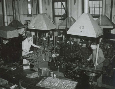 Image of printers using Monotype caster machines. 