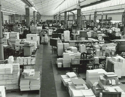 Image of Wembley Print office floor with machinery and stacks of paper