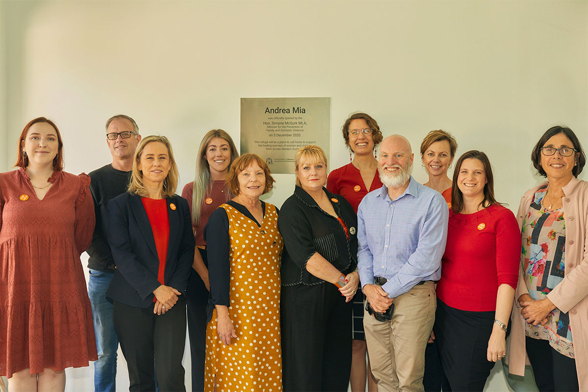 Group shot in front of the Andrea Mia building plaque.