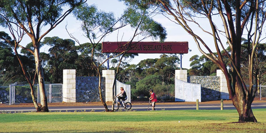 woman and boy riding around the Karlkula bushland park