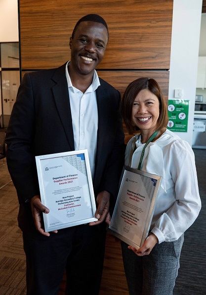 Two smiling award winners holding their certificates at the Finance Supplier Performance Awards 2021.