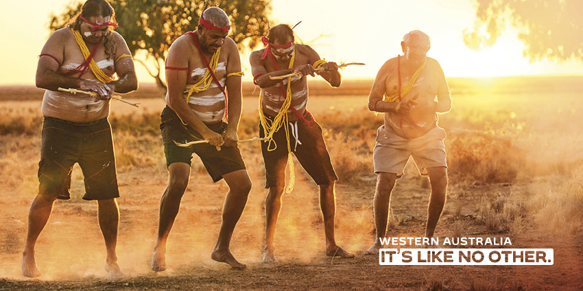 Four first Australians wearing traditional dress with the text Western Australia it's like no other