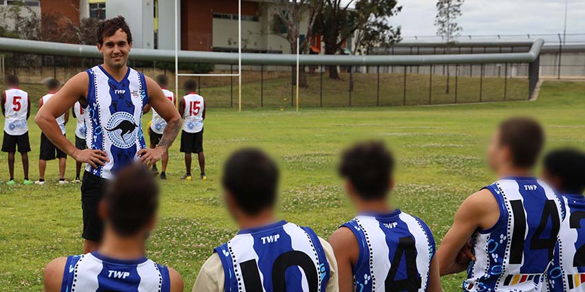 Detainees involved in the football program meet with former West Coast Eagle Brendon Ah Chee to talk about mental health, Aboriginal culture and play a game of football. 