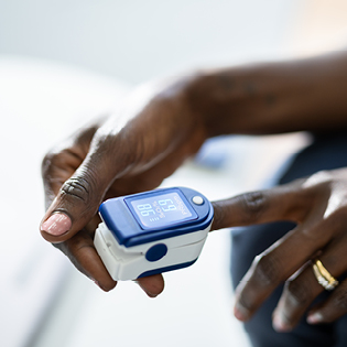 A woman's hands with an oximeter