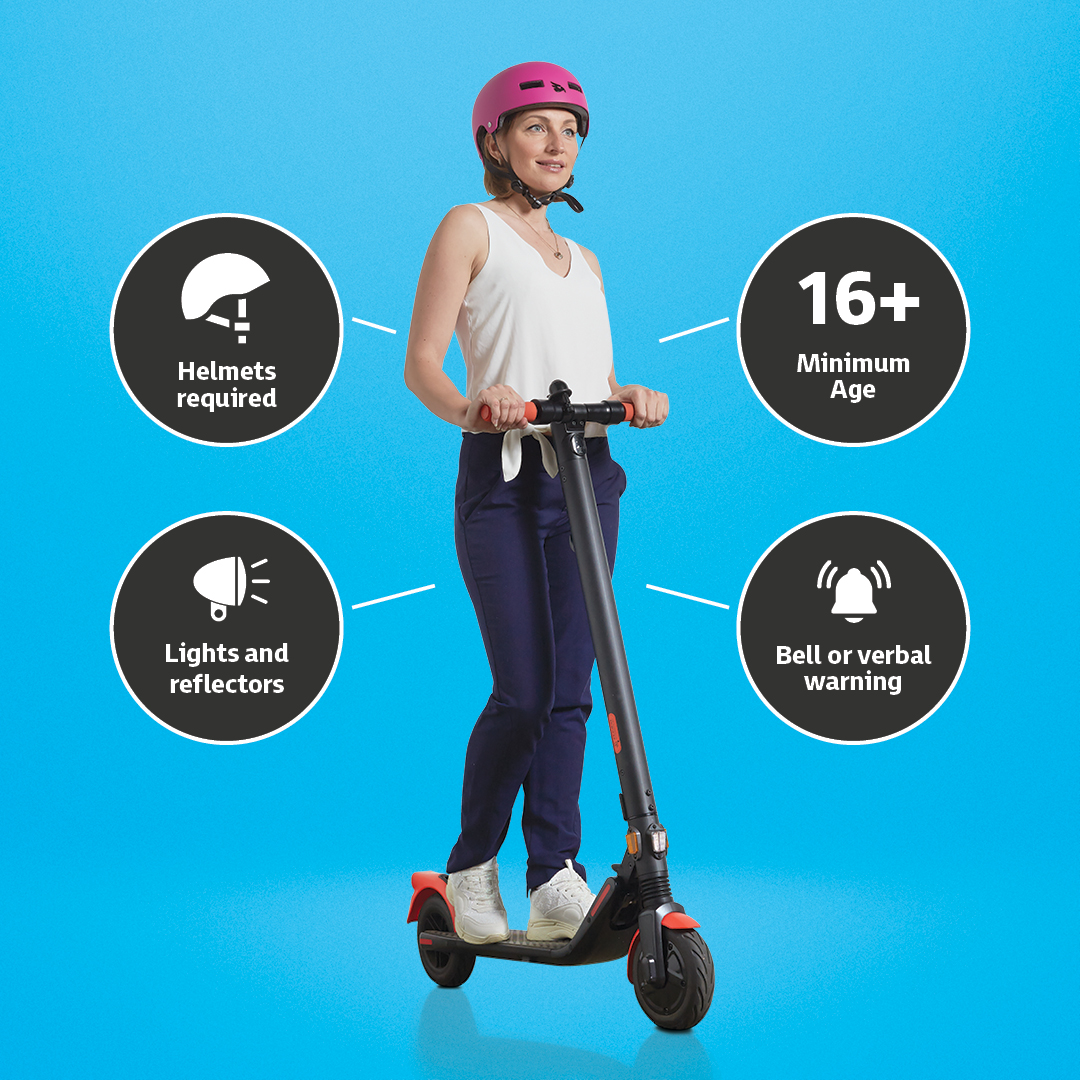 A lady on an escooter wearing a helmet