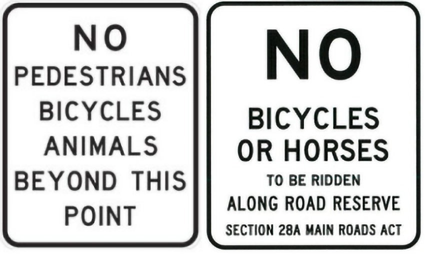 two road access signs advising no horses or bikes on road