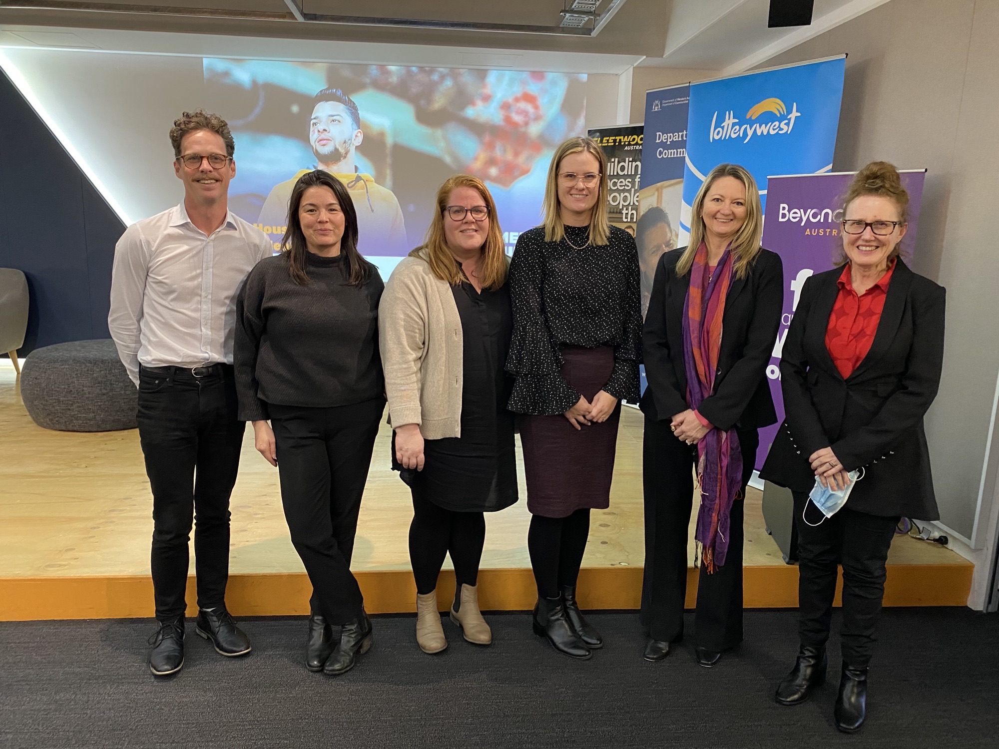 Staff from the Office of Homelessness standing up at the Shelter WA event 