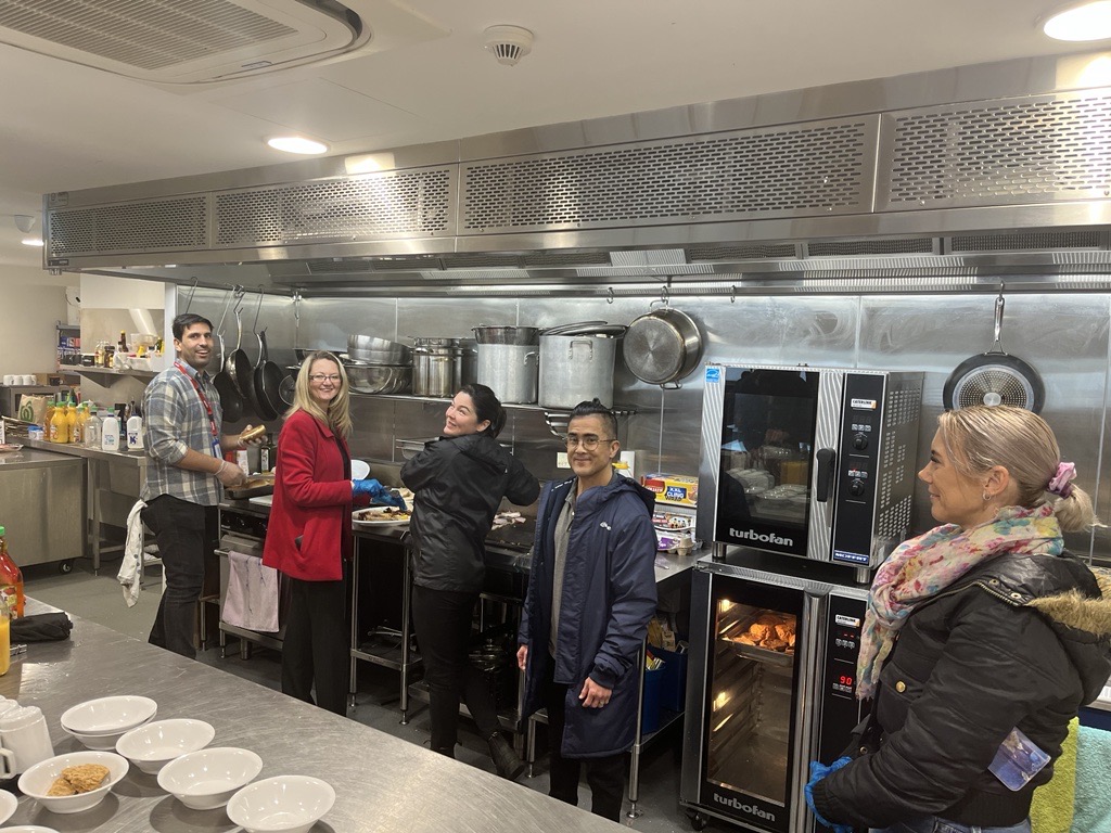 Members of the Office of Homelessness team at Uniting WA Tranby Engagement Hub helping out make breakfast in the kitchen
