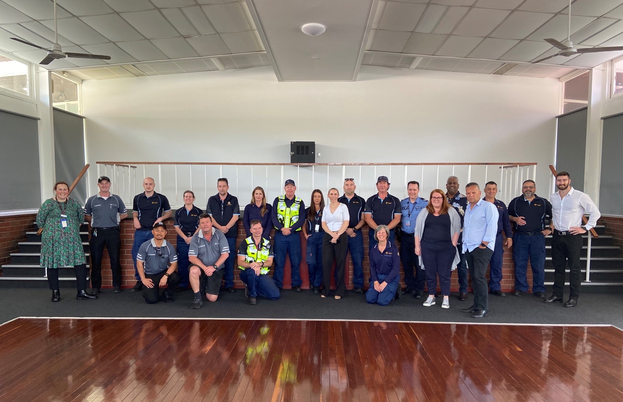 Group of people posing for a photograph in large indoor space