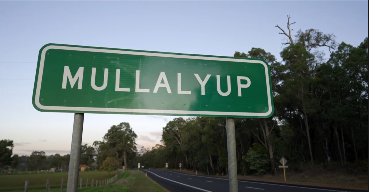 A green road sign that says 'Mullalyup'