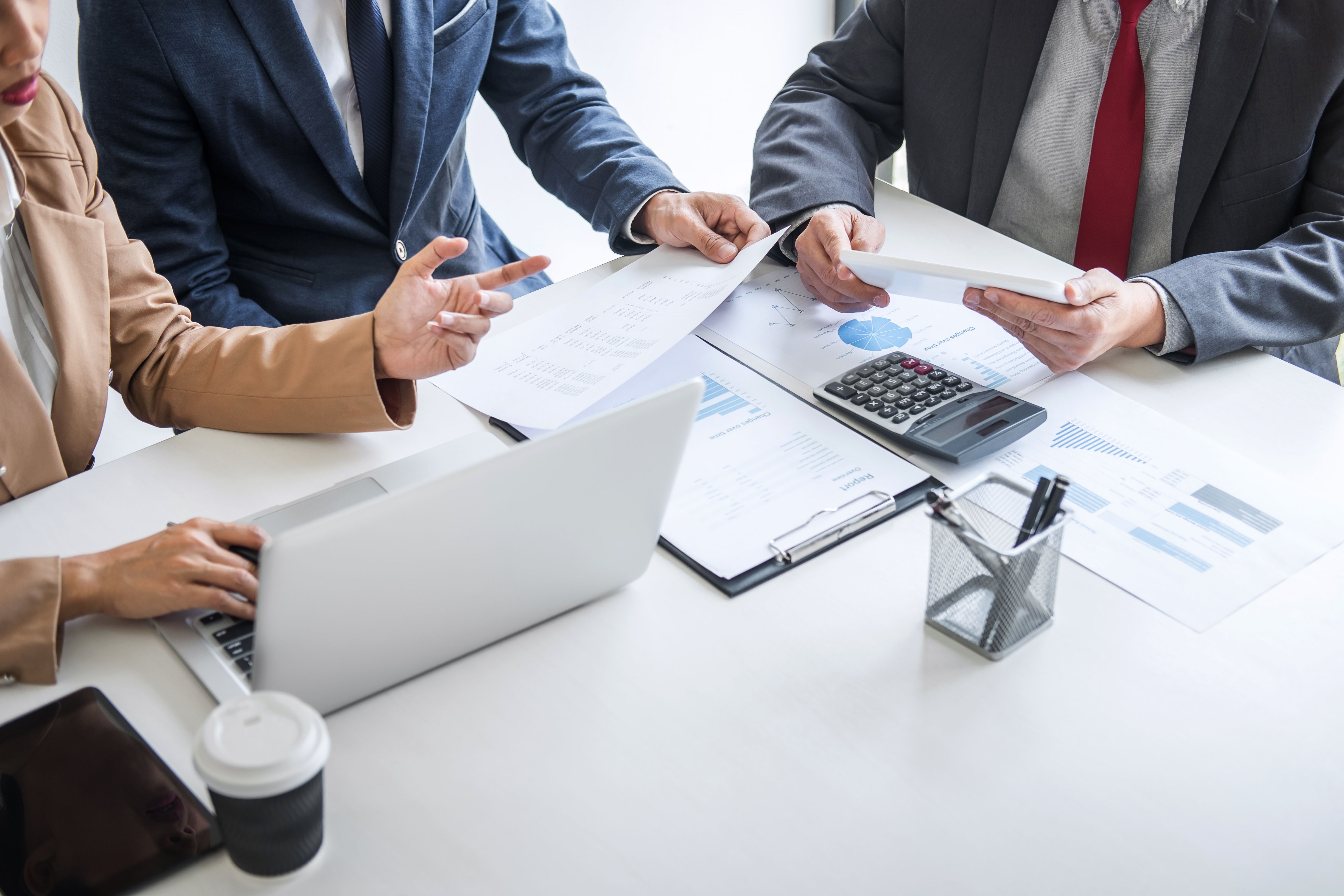 Team of three people sitting around the table