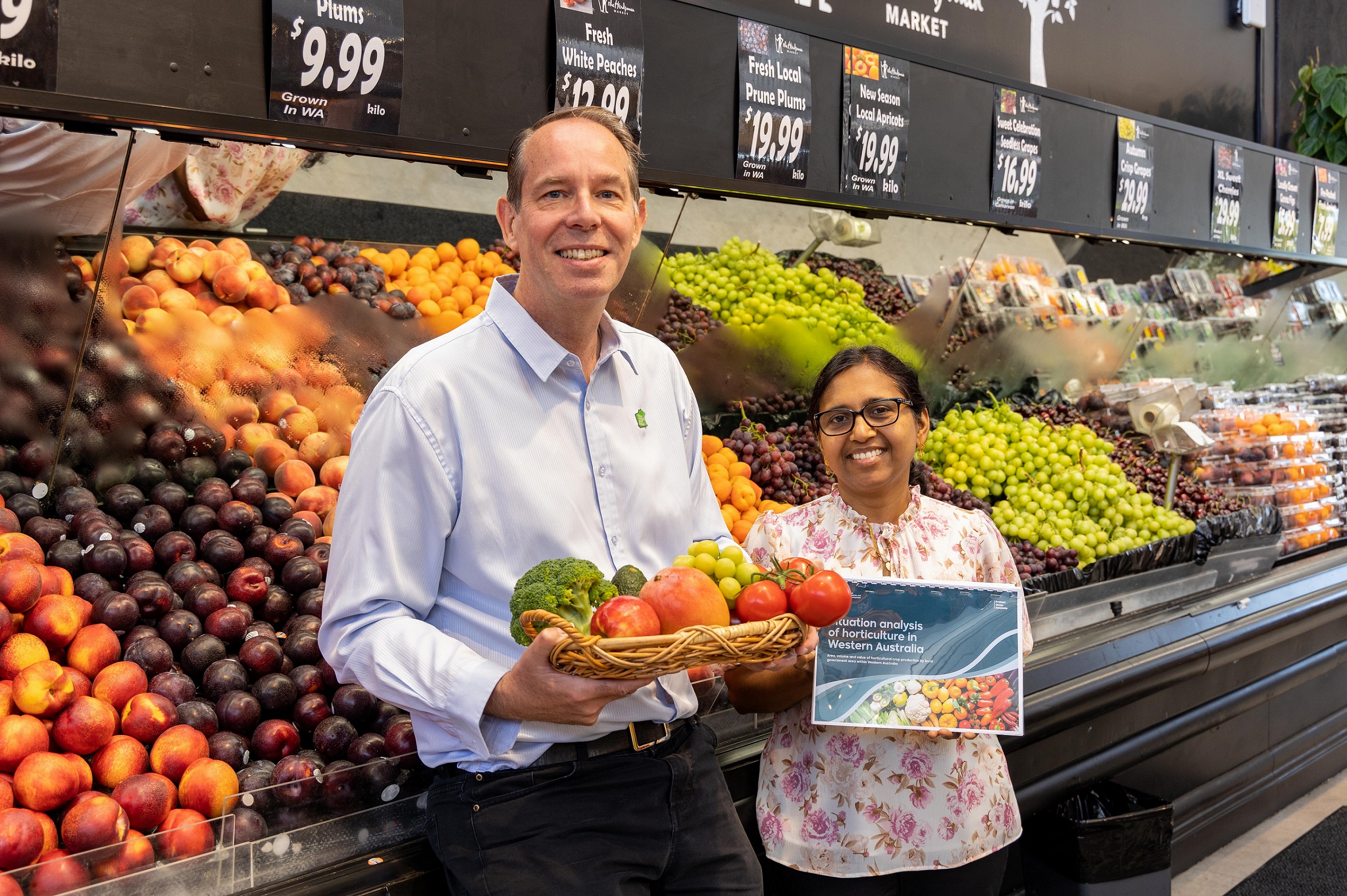 DPIRD officers and report authors Paul Mattingley and Manju Radhakrishnan with newly released report in fruit and vegetable section at local supermarket.