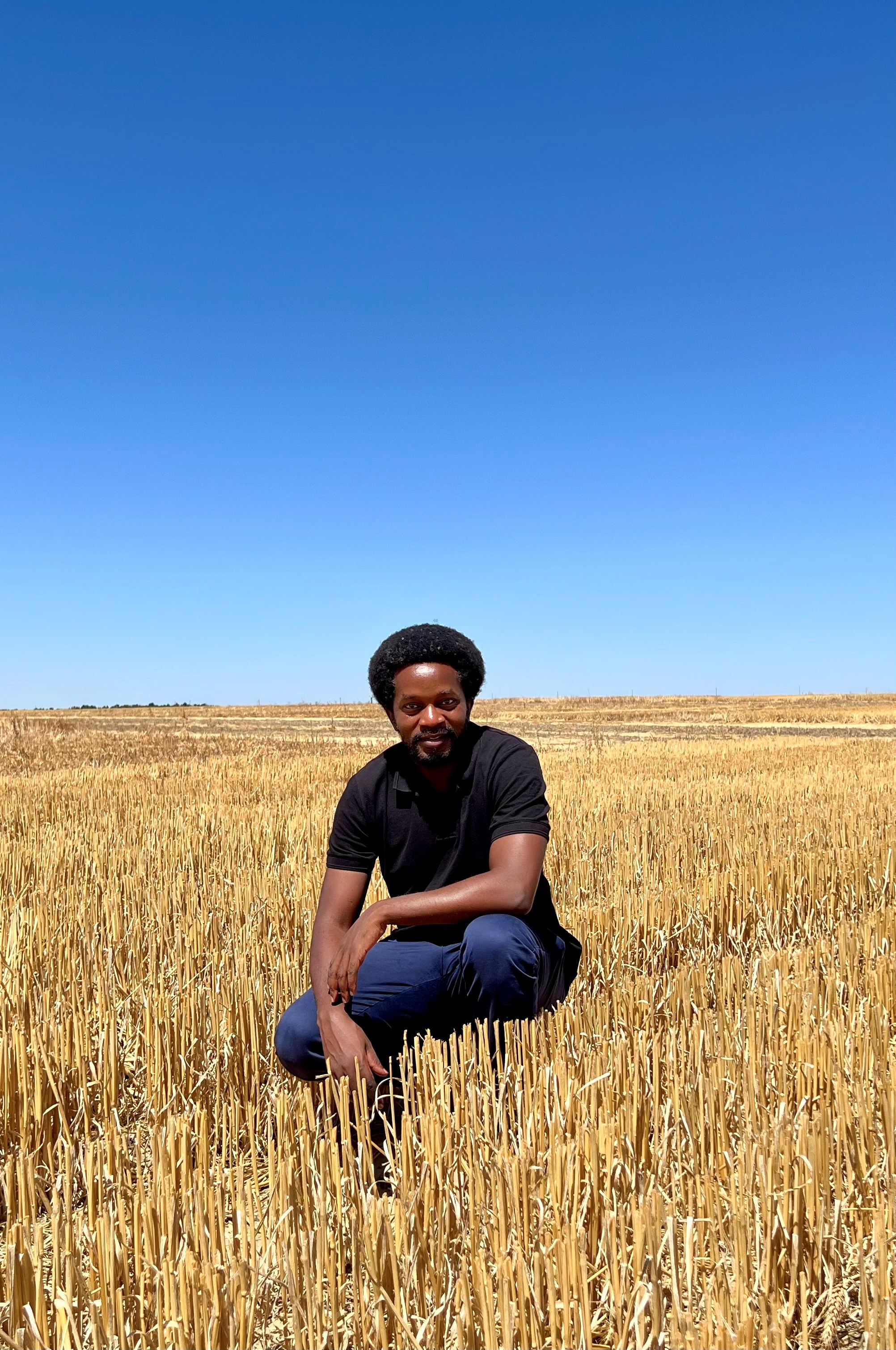 Research scientist George Mwenda in field location.