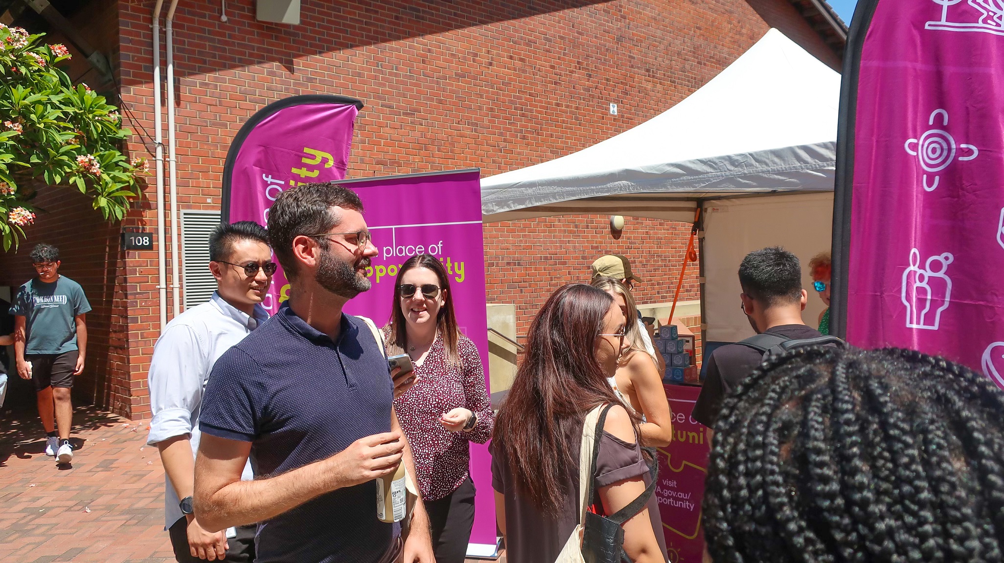 Students at the A place of opportunity stand at Curtin's O-Day