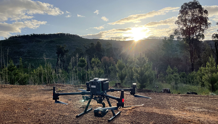 Large drone on gravel track with sunset in background