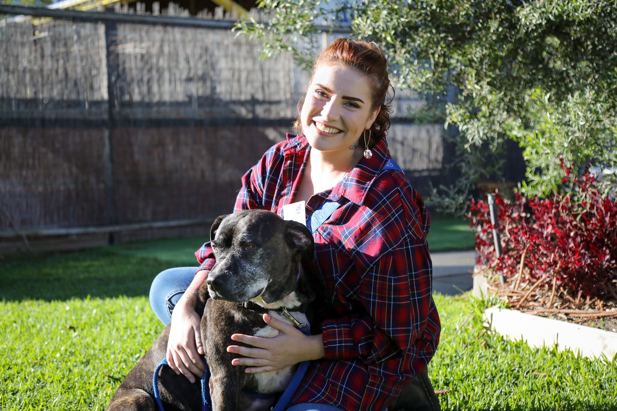 Image with of a young female adult volunteer with a dog