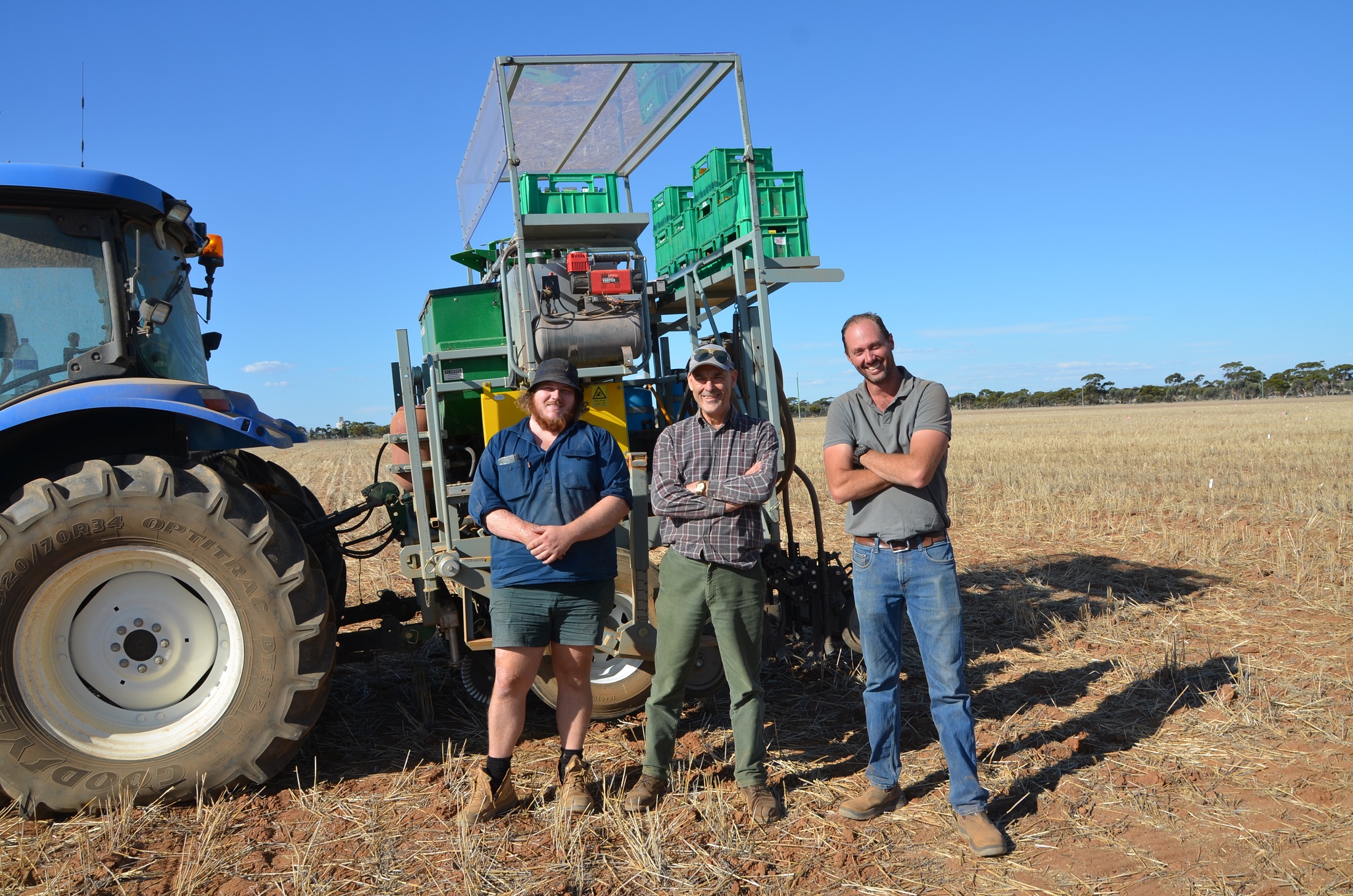 Matt Mills, Bob French and Dion Nichols in front of tractor at Merredin site. 