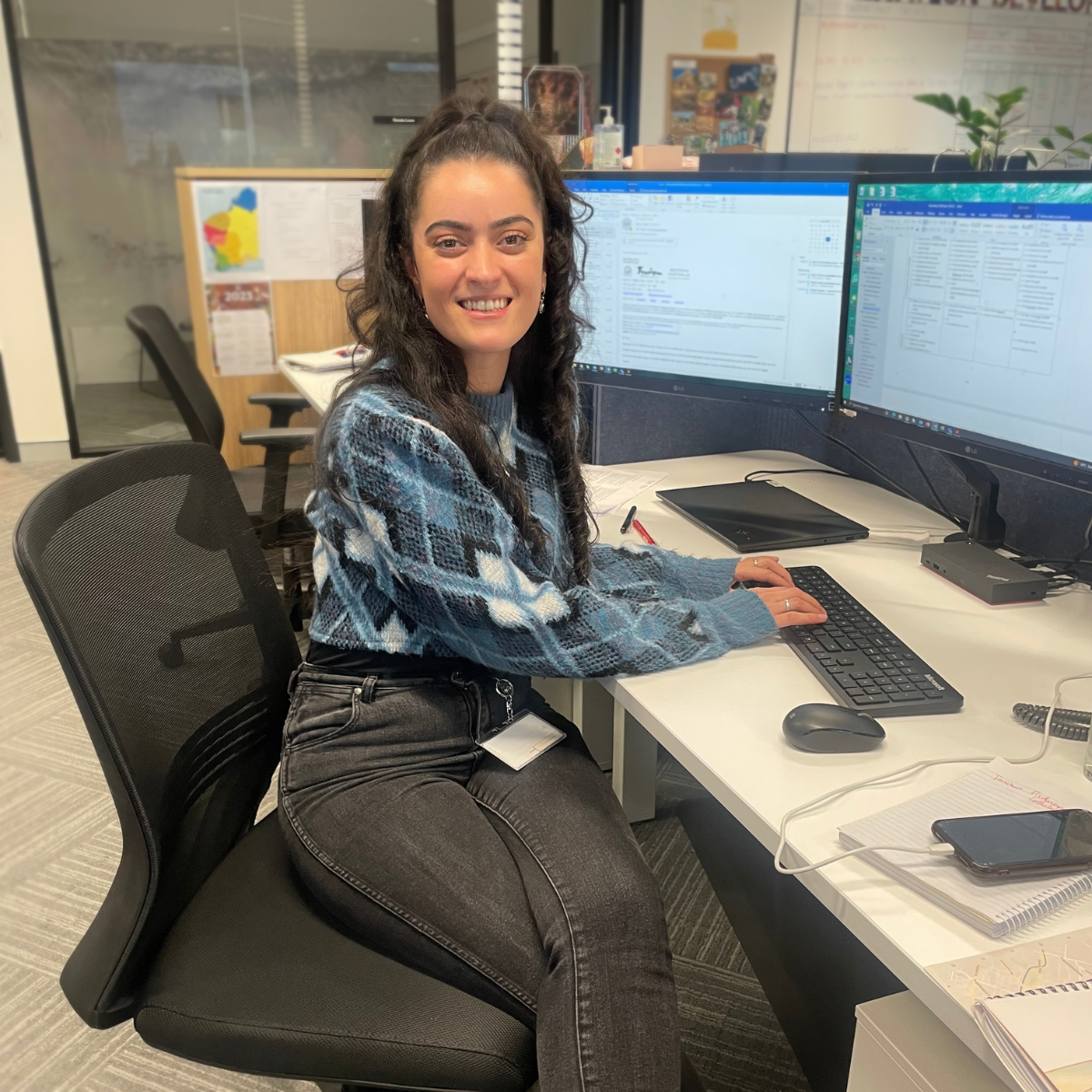 Graduate sitting at her desk using the computer