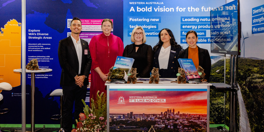 Western Australia representatives standing at the WA booth