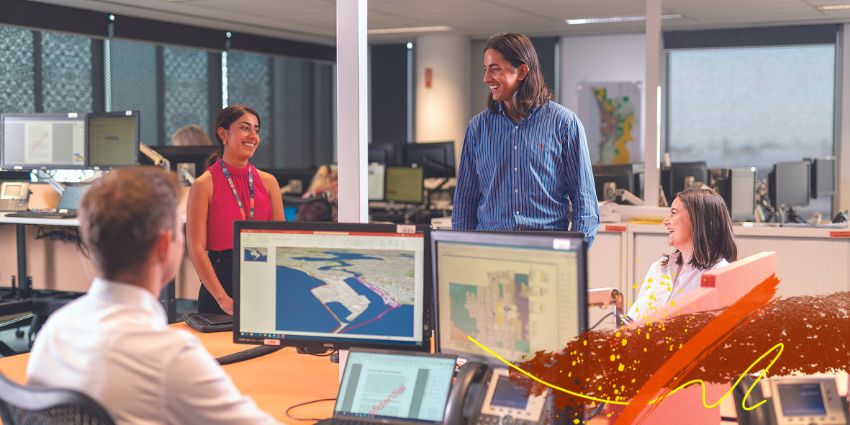 Department staff working and collaborating around a shared office space