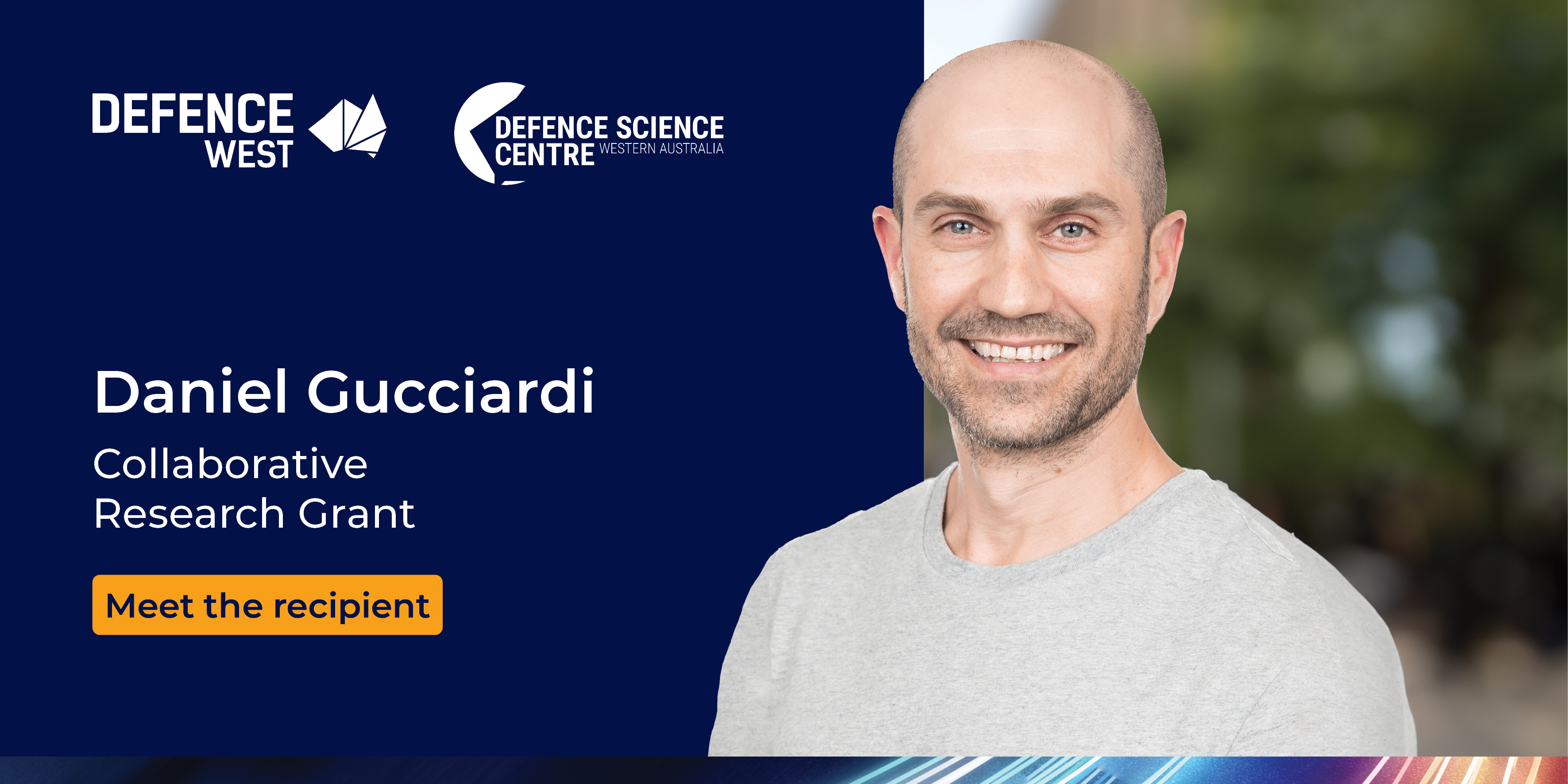 Portrait of man in a grey shirt against a navy blue background. In the navy section is the Defence West and Defence Science Centre logos and the text "Daniel Gucciardi, collaborative research grant. meet the recipient"