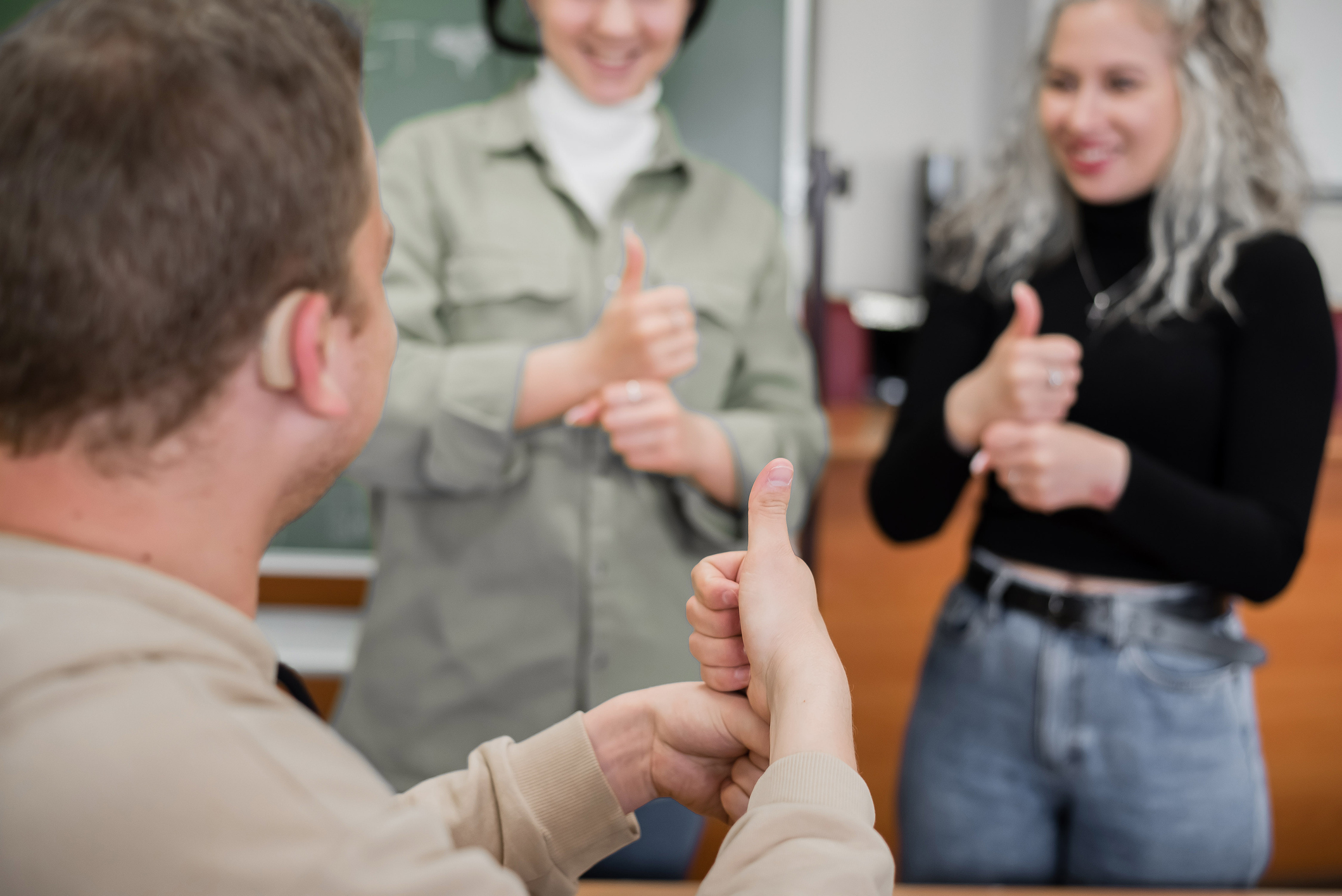 A group of people giving each other a thumbs up gesture