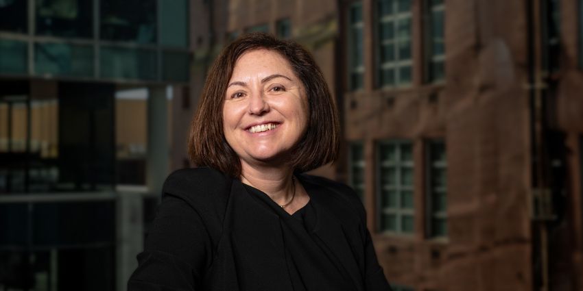 Profile image of Rebecca Moore with a background of a building