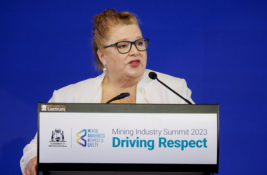 Woman wearing white jacket address the summit