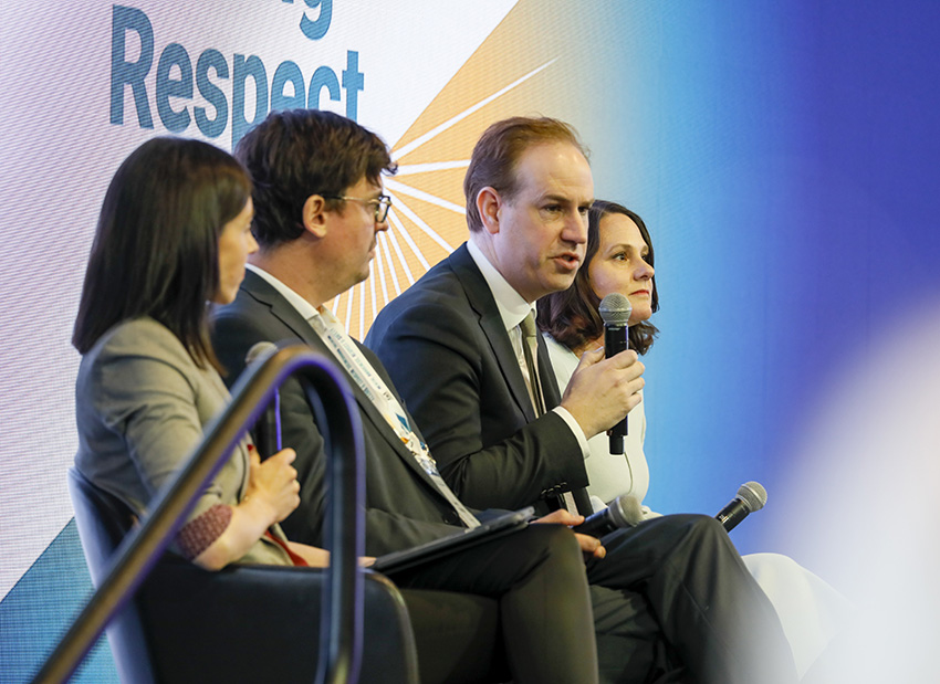 Four well-dressed people discussing Champions for Change