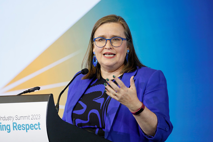 Well-dressed woman addresses the summit