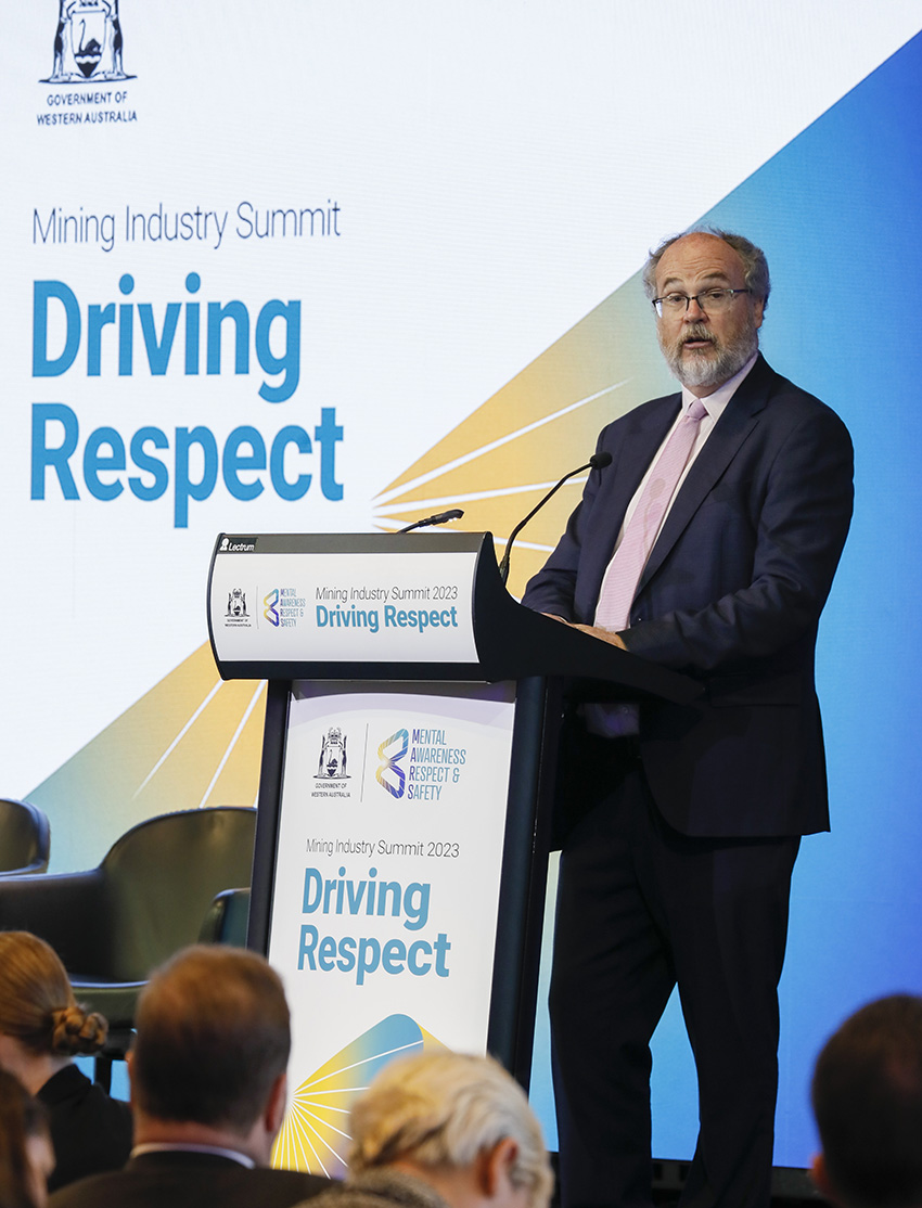 Man in a suit addresses the summit