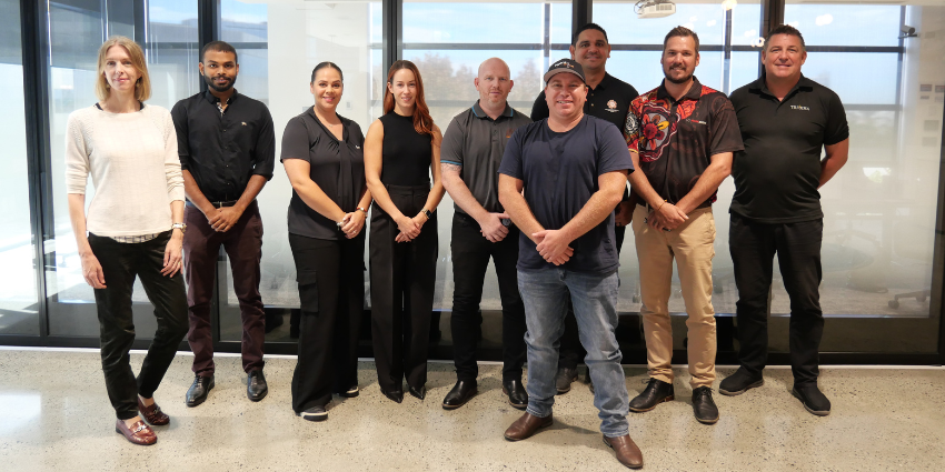 Standing group photo of business representatives