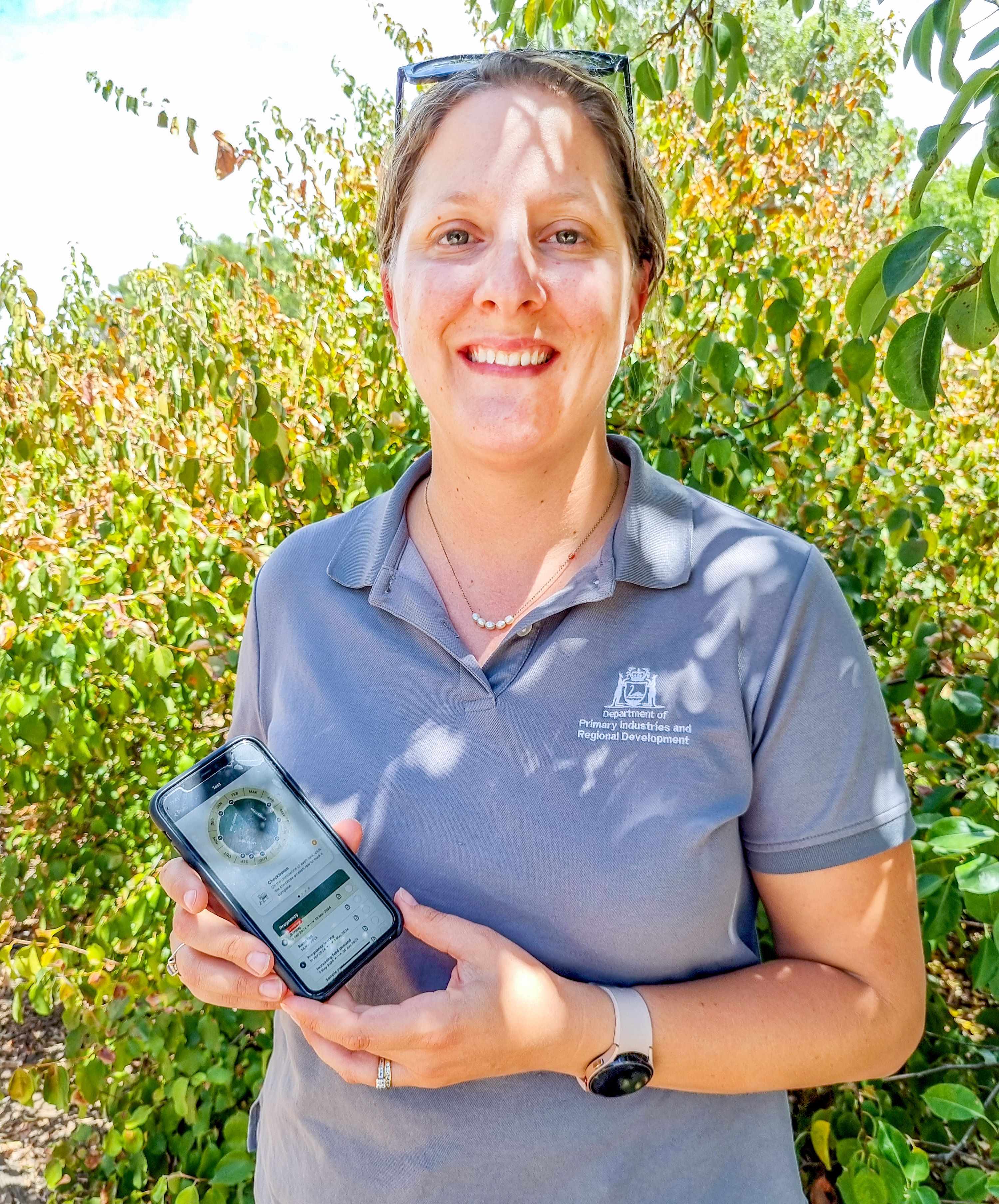 A woman holding a mobile phone.
