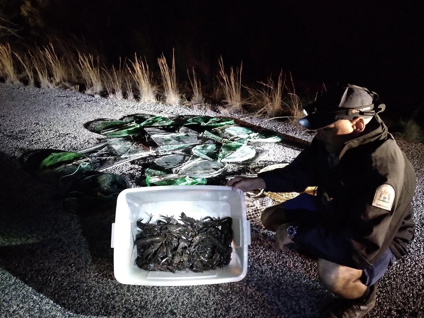 DPIRD fisheries officer with seized marron and fishing gear