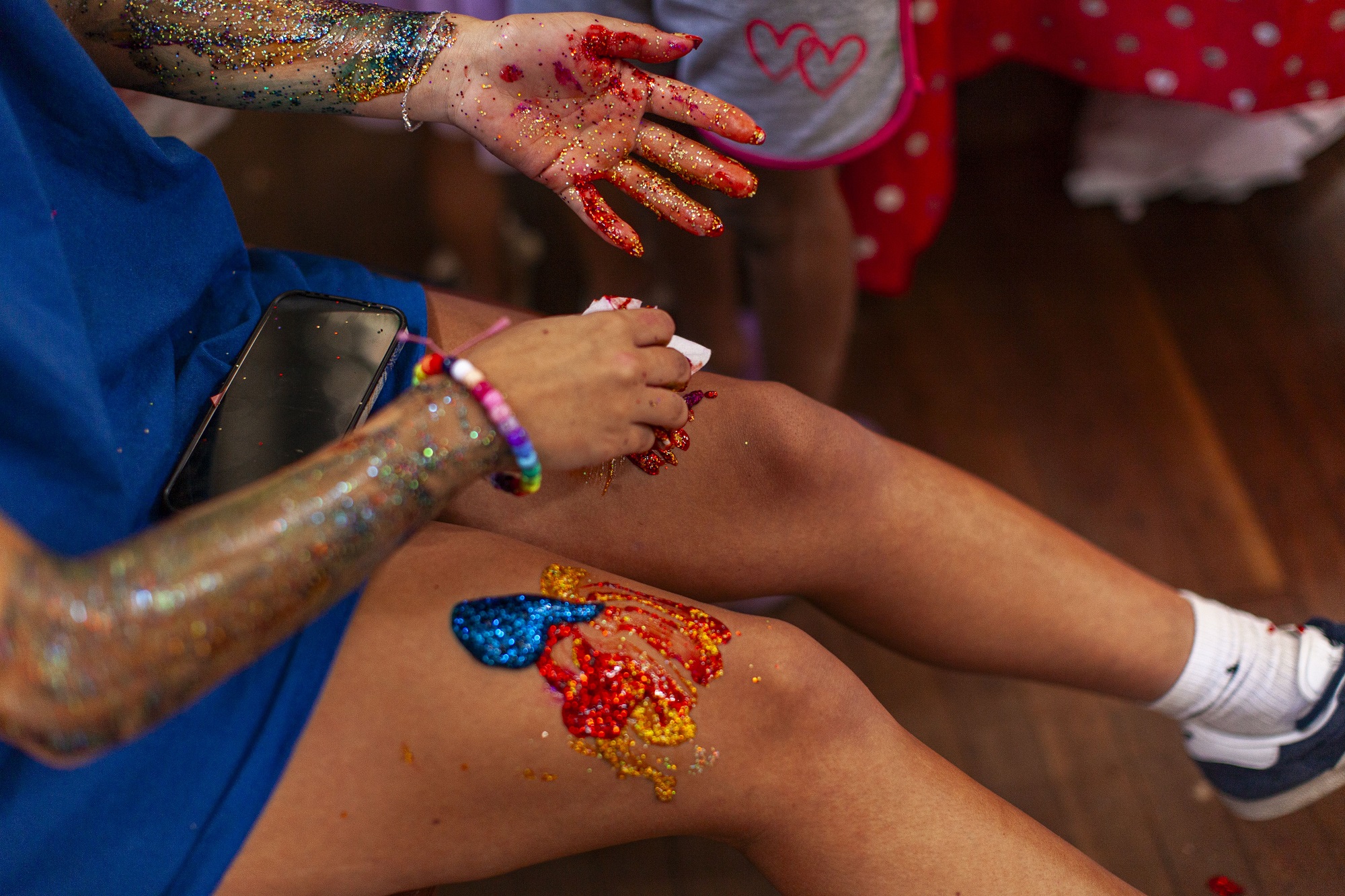 photo of an Aboriginal girl with traditional dance paint on her arms and legs.