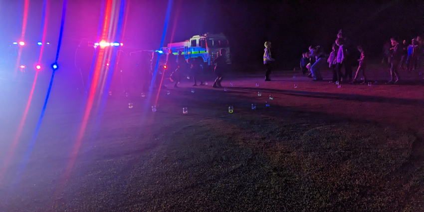 SOCK week memorial - outside on the grass at night