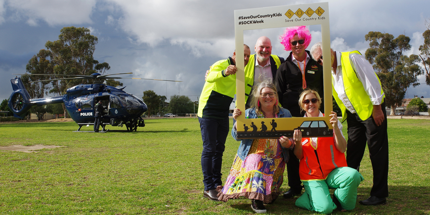 The Commissioner and the Narembeen Shire President posing with a Instagram-style photo frame for SOCK week