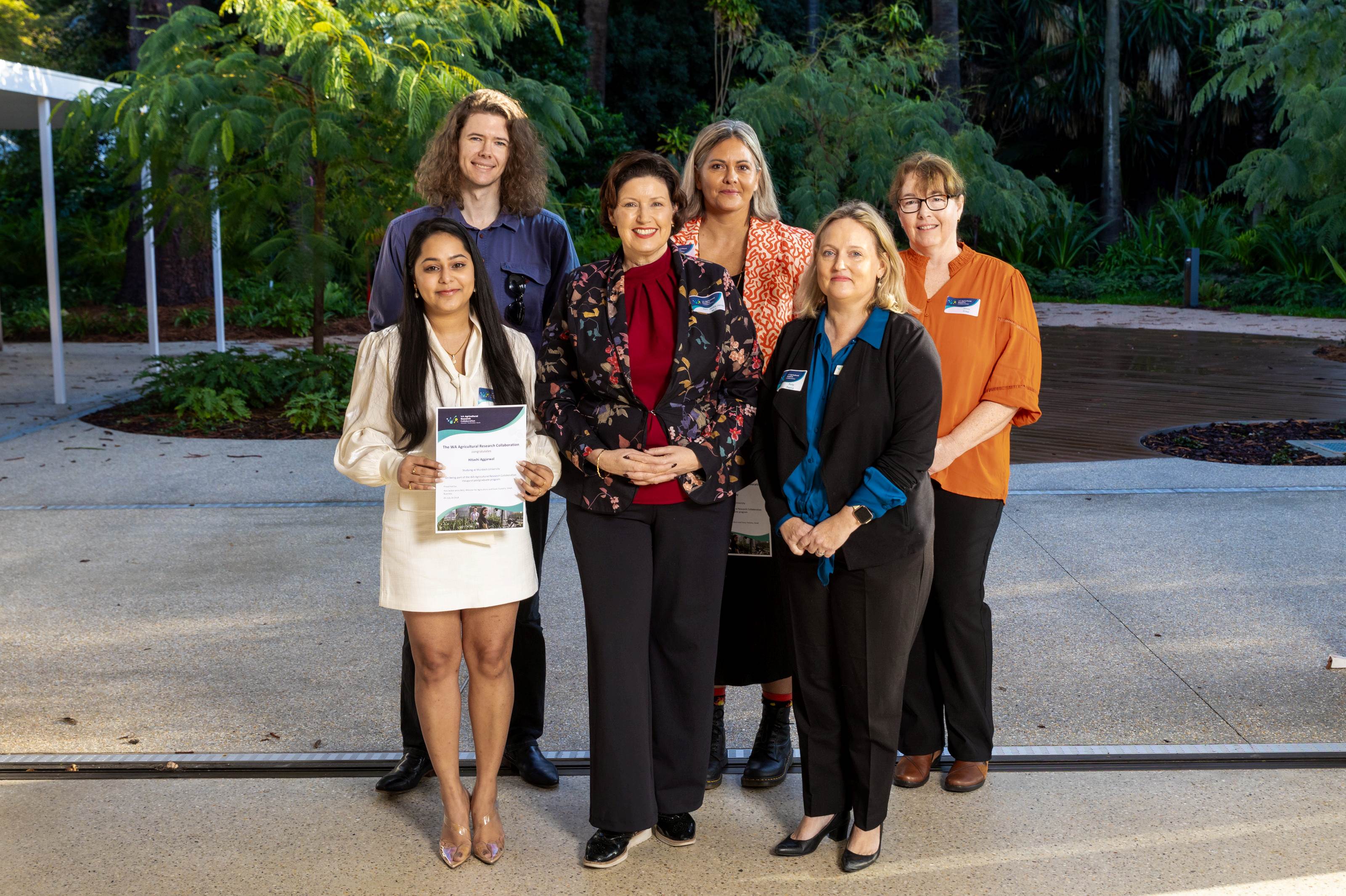 A group of people standing in a courtyard.