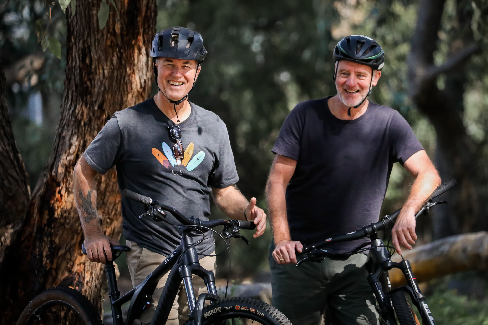 Photo of to middle aged me on push bikes in an outdoor forest setting