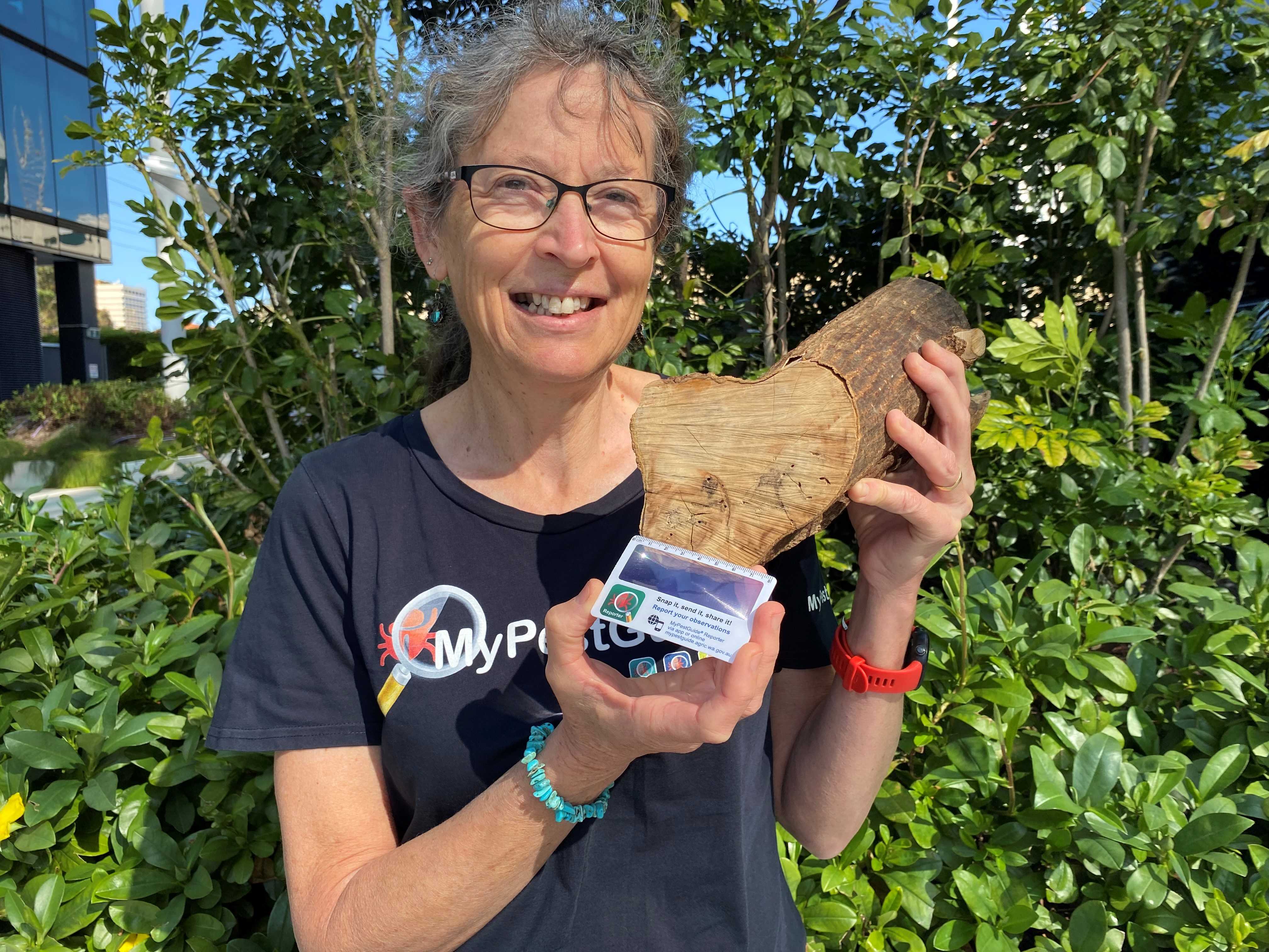 A woman holding a long and a card.