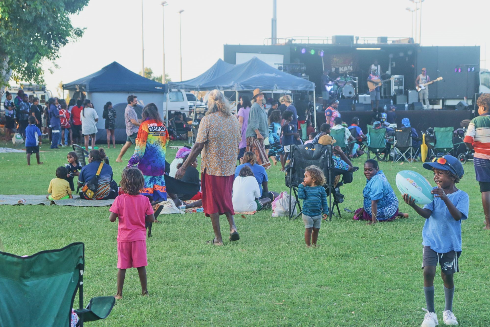 A candid picture of people at a park enjoying a Bidyadanga Aboriginal Community La Grange community event. .