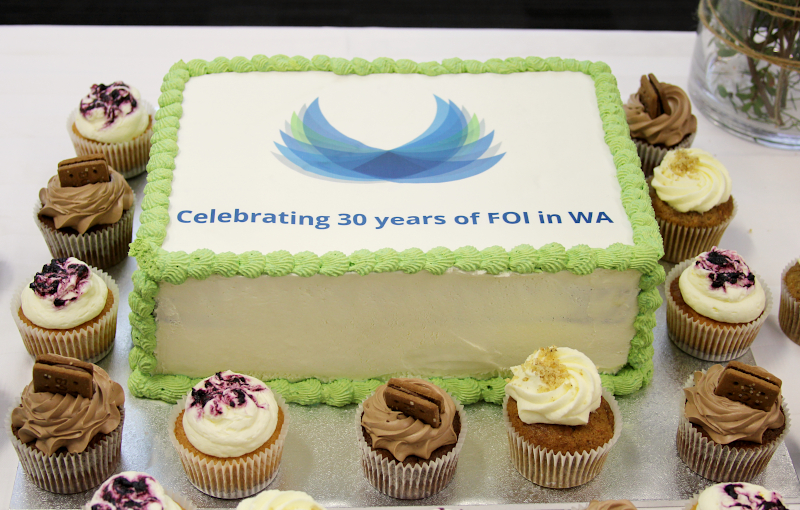 photo of a celebratory cake and cupcakes