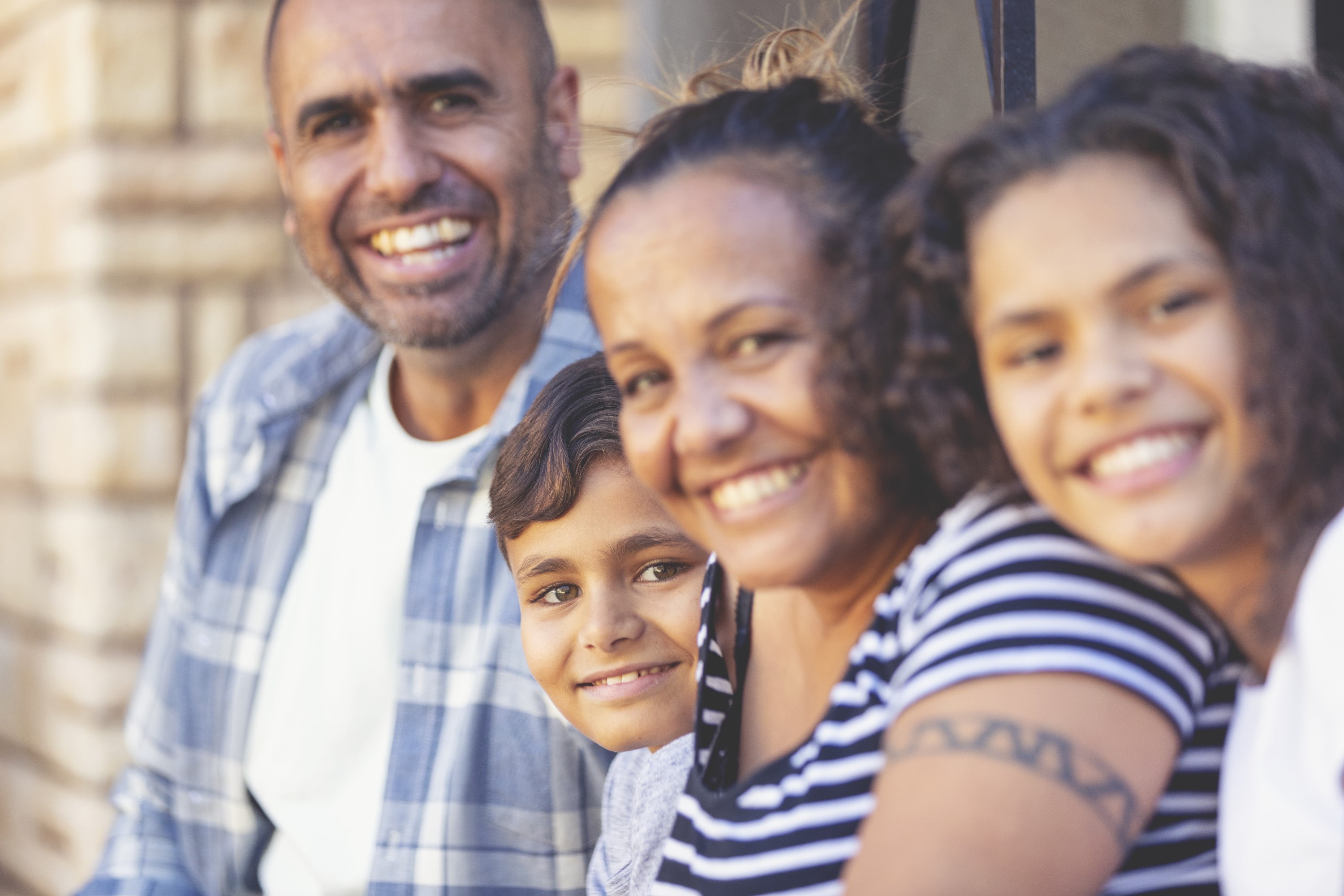 group photo of two young aboriginal adults and and aboriginal boy and girl