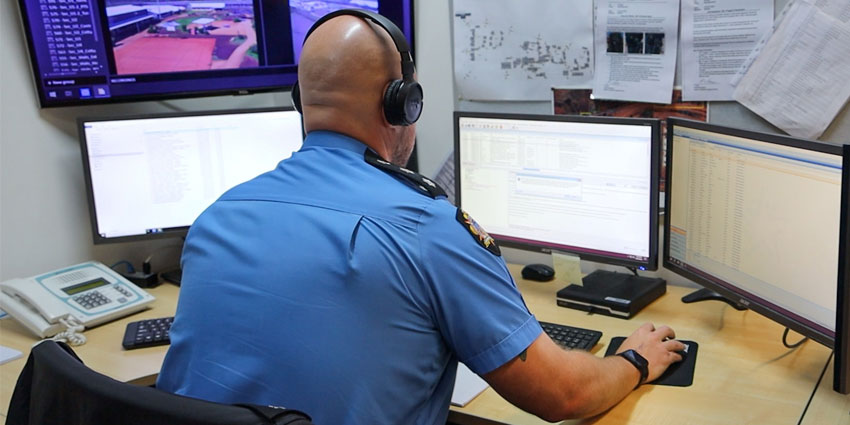 EGRP Prison Officer working and monitoring at a workstation