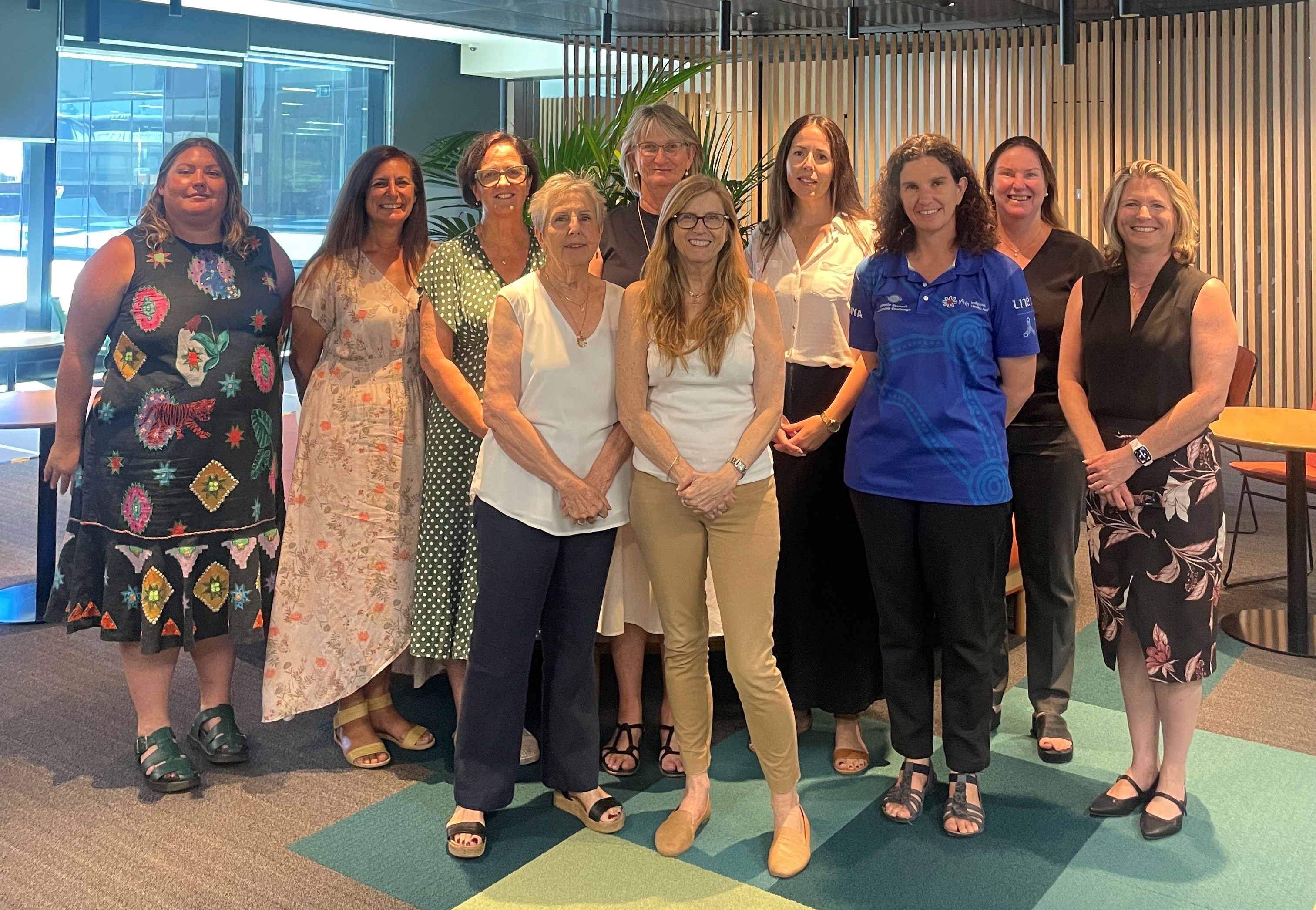Group photo of about ten adults in an office environment. They are the Care Plan Review Panel members