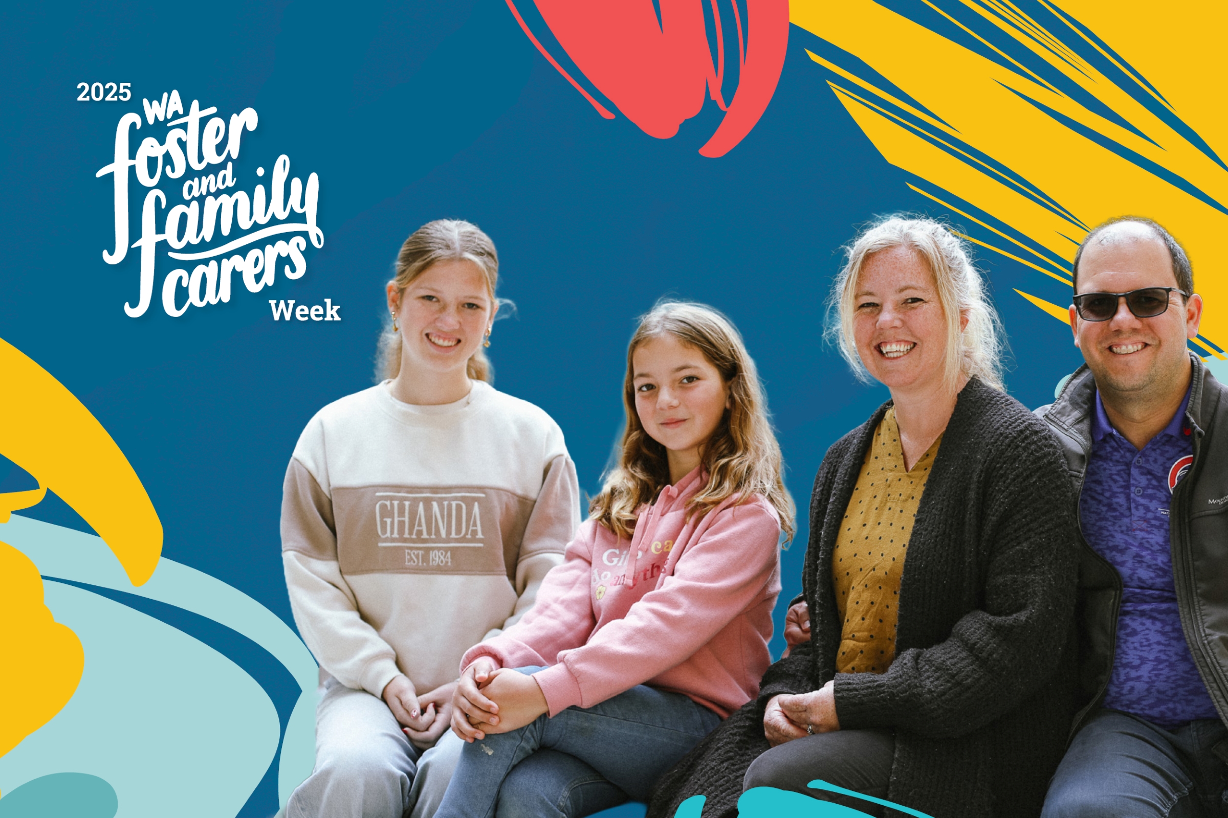 Two adults and two children in casual clothing looking happy and smiling, with 