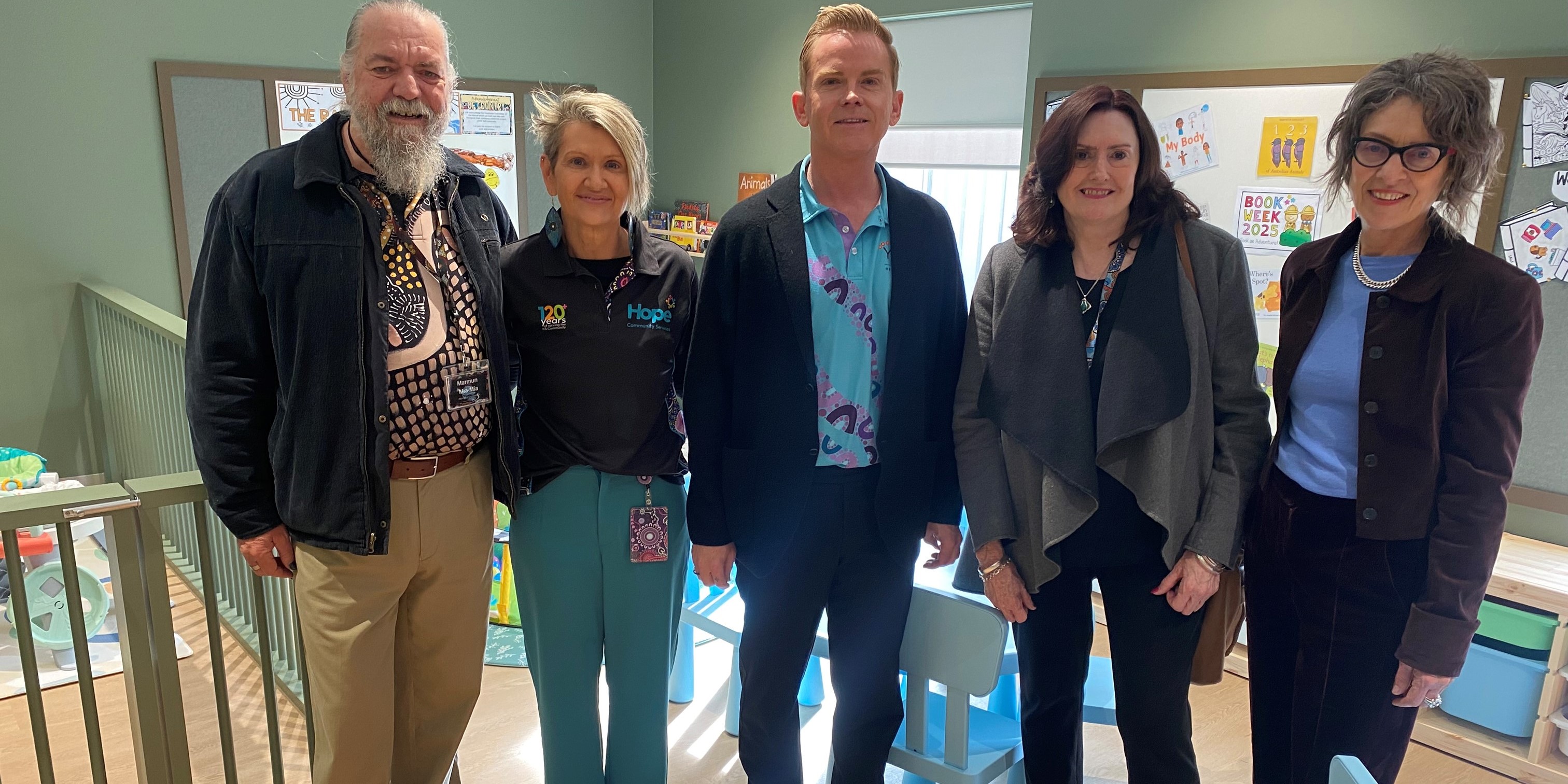 Indoor group photo of five stakeholders at the Armadale FDV one stop hub